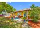 Charming home with a cozy front porch, colorful landscaping, and a welcoming entrance at 5236 Madison St, New Port Richey, FL 34652