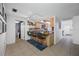 Kitchen with breakfast bar featuring light wood cabinetry, tile backsplash, and open layout to the rest of the home at 5236 Madison St, New Port Richey, FL 34652