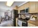Charming kitchen featuring stainless steel appliances, light wood cabinetry, and adjacent dining area at 5236 Madison St, New Port Richey, FL 34652
