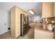 Bright kitchen with stainless steel appliances, wood cabinetry, tile floors, and a built-in pantry at 5236 Madison St, New Port Richey, FL 34652