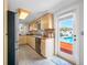 Well-lit kitchen with stainless steel appliances, wood cabinets, and access to the pool area at 5236 Madison St, New Port Richey, FL 34652