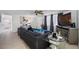 Comfortable living room featuring a dark gray sectional sofa, ceiling fan, and large TV at 5236 Madison St, New Port Richey, FL 34652