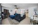 Comfortable living room with dark gray sectional sofa, ceiling fan, and stylish decor at 5236 Madison St, New Port Richey, FL 34652