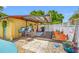Outdoor kitchen with a covered patio, bar seating, and a grill, ideal for outdoor entertaining at 5236 Madison St, New Port Richey, FL 34652