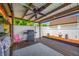Covered patio featuring a ceiling fan, wooden deck, outdoor grill and privacy fence at 5236 Madison St, New Port Richey, FL 34652