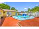 Backyard oasis featuring a sparkling pool with a basketball hoop, lounge chairs, and patio area at 5236 Madison St, New Port Richey, FL 34652