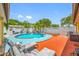 Stunning backyard with a vibrant blue pool, comfortable lounge seating, and well-manicured landscaping at 5236 Madison St, New Port Richey, FL 34652