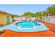 Inviting backyard pool area surrounded by lush landscaping, perfect for relaxation and entertainment at 5236 Madison St, New Port Richey, FL 34652
