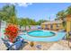 Beautiful backyard featuring a sparkling pool with a spa, lounge chairs, and lush greenery at 5236 Madison St, New Port Richey, FL 34652