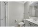 Bright bathroom features a shower, toilet and vanity with a mirror and sink at 5396 Berrien Ave, Spring Hill, FL 34608