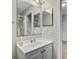 Bathroom featuring a large mirror, a vanity and shower with glass door at 5396 Berrien Ave, Spring Hill, FL 34608