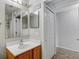 Bright bathroom featuring a wooden vanity with a modern sink and a large mirror with overhead lighting at 5396 Berrien Ave, Spring Hill, FL 34608