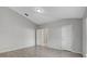 Bright bedroom with tile floors, neutral paint, and an ensuite bathroom at 5396 Berrien Ave, Spring Hill, FL 34608