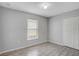 Bedroom features wood-look floors, natural light, closet and neutral paint at 5396 Berrien Ave, Spring Hill, FL 34608