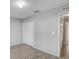 This bedroom has neutral walls, wood-look floors, a closet, and an entry into the bathroom at 5396 Berrien Ave, Spring Hill, FL 34608