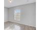 Bedroom with wood-look tile, window, and neutral paint at 5396 Berrien Ave, Spring Hill, FL 34608
