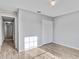Well-lit bedroom features wood-look floors, a closet and access to a hallway at 5396 Berrien Ave, Spring Hill, FL 34608