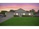 Charming single-story home with a well-maintained lawn and an attached two-car garage at sunset at 5396 Berrien Ave, Spring Hill, FL 34608