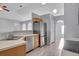 Updated kitchen featuring stainless steel appliances and a breakfast bar open to the living area at 5396 Berrien Ave, Spring Hill, FL 34608