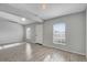 Bright living room featuring wood floors, large windows, and a welcoming entrance at 5396 Berrien Ave, Spring Hill, FL 34608