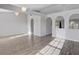 Open-concept living room with wood floors, arched doorways, and plenty of natural light at 5396 Berrien Ave, Spring Hill, FL 34608