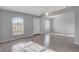 Bright living room featuring wood floors, large windows, and a welcoming entrance at 5396 Berrien Ave, Spring Hill, FL 34608