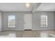 Bright living room featuring wood floors, large windows, and a welcoming entrance at 5396 Berrien Ave, Spring Hill, FL 34608