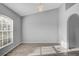 Bright living room with wood floors, a modern light fixture, and large windows with blinds at 5396 Berrien Ave, Spring Hill, FL 34608