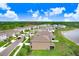 Aerial view of a residential community near a body of water, showcasing numerous single-Gathering homes at 5430 Thistle Field Ct, Wesley Chapel, FL 33545