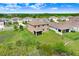 Aerial view of home's backyard featuring a screened-in porch, green grass, and a scenic pond at 5430 Thistle Field Ct, Wesley Chapel, FL 33545