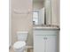 Bright bathroom with a granite countertop vanity and white cabinet storage at 5430 Thistle Field Ct, Wesley Chapel, FL 33545