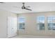 Light bedroom featuring double door closet and multiple windows at 5430 Thistle Field Ct, Wesley Chapel, FL 33545