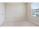 Neutral bedroom with carpet, closet and a window offering natural light, creating a calming space at 5430 Thistle Field Ct, Wesley Chapel, FL 33545