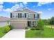Charming two-story home featuring a well-manicured lawn, inviting entrance, and attached two car garage at 5430 Thistle Field Ct, Wesley Chapel, FL 33545