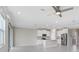 Spacious kitchen with white cabinets and an island, seamlessly connecting to the living area at 5430 Thistle Field Ct, Wesley Chapel, FL 33545