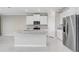 Well-equipped kitchen featuring a center island, stainless steel appliances, and sleek countertops at 5430 Thistle Field Ct, Wesley Chapel, FL 33545