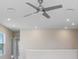 Second-floor living room featuring tile flooring, ceiling fan, and multiple windows at 5430 Thistle Field Ct, Wesley Chapel, FL 33545