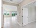 Bright, airy living room featuring white tile floors and large windows with natural light at 5430 Thistle Field Ct, Wesley Chapel, FL 33545