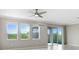 Bright living room featuring large windows that offer beautiful views at 5430 Thistle Field Ct, Wesley Chapel, FL 33545