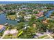 Wide aerial view of waterfront property with dock, boat lift, and mature trees at 560 Bosphorous Ave, Tampa, FL 33606
