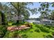Expansive backyard featuring mature trees, a custom treehouse, and boat dock access to the water at 560 Bosphorous Ave, Tampa, FL 33606