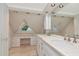 Bathroom with double sink vanity, tiled floor, and large mirror at 560 Bosphorous Ave, Tampa, FL 33606