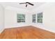 Bright bedroom with hardwood floors, white walls, and two large windows at 560 Bosphorous Ave, Tampa, FL 33606