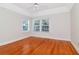 Bright bedroom with hardwood floors, white walls, and two large windows at 560 Bosphorous Ave, Tampa, FL 33606