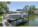 Boat on lift on the canal in a relaxing backyard scene. The canal leads out to open waters at 560 Bosphorous Ave, Tampa, FL 33606