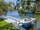 A modern boat and dock are shown, with a lift and space for outdoor enjoyment at 560 Bosphorous Ave, Tampa, FL 33606
