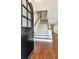 Grand entryway featuring an arched front door and staircase with wooden handrail at 560 Bosphorous Ave, Tampa, FL 33606