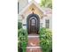 Charming home entrance features a beautiful black framed front door and a brick walkway at 560 Bosphorous Ave, Tampa, FL 33606