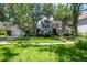 Beautiful home exterior with a well-manicured lawn and lush landscaping and mature shade trees at 560 Bosphorous Ave, Tampa, FL 33606