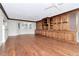 Large living room featuring custom built-in shelving and cabinetry with hardwood flooring at 560 Bosphorous Ave, Tampa, FL 33606